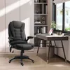A black massage office chair is placed next to a desk in a home office setting. Produktbild-Vorschau