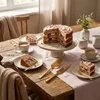 A cake and coffee set up on a wooden table with a pink tablecloth. Anteprima dell’immagine prodotto