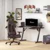 A gaming setup with a chair, desk, computer, and accessories in a room. Produktbild-Vorschau