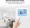 A hand is shown pressing a button on a white thermostat mounted on a wall, with a blurred office or living space in the background. Podgląd zdjęcia produktu