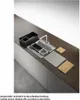 A modern kitchen sink setup with various accessories arranged on a countertop. Voir les images du produit