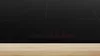 A close-up shot of a black induction hob with red digital displays, resting on a wooden surface. Anteprima dell’immagine prodotto