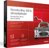 The image shows the front and side of a Mercedes-Benz 300 SL Advent Calendar box. The front features text and an illustration of the car, while the side has vertical text. The background is a gradient of red. Produktbild-Vorschau