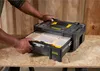 A person's hands are shown opening a drawer on a black and yellow tool storage box. Voir les images du produit