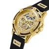 A close-up, angled view of a gold and black Guess watch with diamond accents. Podgląd zdjęcia produktu