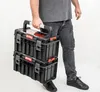 A person is holding two stacked toolboxes. Náhled obrázku produktu
