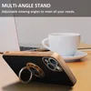 A phone case with a ring stand is placed on a desk next to a laptop and a coffee cup. Produktbild-Vorschau