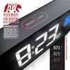 Close-up of a digital alarm clock displaying the time and feature indicators, with German text explaining its functions. Náhľad obrázku produktu