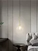 A modern bedroom setting with a pendant light above a side table next to a bed. Anteprima dell’immagine prodotto