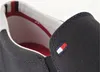 A close-up view of the side and opening of a navy blue slip-on sneaker. Náhled obrázku produktu