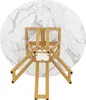 A top-down view of a round dining table with a marble-like surface and a golden metal base. Podgląd zdjęcia produktu