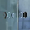 Two glass doors with black circular handles. Produktbild-Vorschau