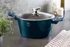 A dark teal pot with a glass lid sits on a countertop next to a plant and a checkered cloth. Produktbild-Vorschau