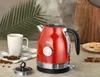 A red electric kettle is shown on a countertop next to a white mug and coffee beans. Podgląd zdjęcia produktu