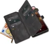A black leather wallet case with cards, money, and coins inside, shown open with a smartphone partially visible. Produktbild-Vorschau