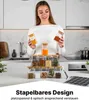 A woman is holding spice jars in a kitchen setting, with a set of spice jars displayed on a counter. Anteprima dell’immagine prodotto