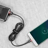 A black and red braided micro USB cable is shown connecting a smartphone to a power bank. Náhled obrázku produktu