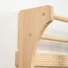 A close-up view of a wooden climbing frame attached to a white wall. Náhľad obrázku produktu