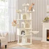A multi-level cat tree with several platforms, perches, and enclosed spaces, occupied by three cats. The cat tree is situated in a room with a fireplace and a window with sheer curtains. Produktbild-Vorschau