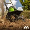 A person is using a green electric tiller to cultivate soil in a garden. Náhľad obrázku produktu