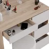 A close-up view of a vanity table with drawers open, showing makeup and personal items. Náhled obrázku produktu