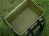 An open green bag is placed on grass. Anteprima dell’immagine prodotto