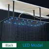 A black LED shower head mounted on the ceiling, with water flowing and blue lights illuminated. Produktbild-Vorschau