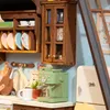 A miniature kitchen scene with various appliances and accessories. Náhľad obrázku produktu