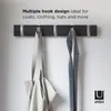 A wall-mounted coat rack with hooks holding a bag and a tie. Anteprima dell’immagine prodotto