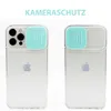 Two iPhones in clear cases with aqua camera lens protectors, presented side-by-side against a white background. Produktbild-Vorschau