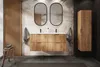 A modern bathroom with a wooden vanity, tropical wallpaper, and two oval mirrors. Náhľad obrázku produktu