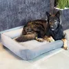 A dog is lying on a dog bed in a modern interior setting. Produktbild-Vorschau