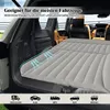 An inflatable mattress is laid out in the back of an SUV, with the trunk open. Náhled obrázku produktu