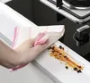 A hand is cleaning a dirty stovetop with a cloth. Náhľad obrázku produktu