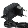 A black power adapter with a European plug and a coiled black cable. Produktbild-Vorschau