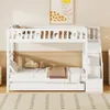 A white bunk bed with a trundle bed, decorated with star and moon cutouts on the top bunk's railing. The bed is made up with white bedding and a brown blanket. Produktbild-Vorschau