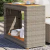 An outdoor setting with a table and books. Náhled obrázku produktu