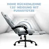 A grey ergonomic gaming chair with its backrest reclined and footrest extended, shown in a bright, modern setting with lines indicating the recline angle. Produktbild-Vorschau