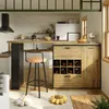A modern kitchen and dining area with a bar counter, stools, and a wine cabinet. Produktbild-Vorschau