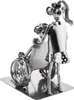 A metal figurine of a caregiver pushing a person in a wheelchair. Voir les images du produit