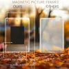 A comparison of two magnetic picture frames, one labeled 'OURS' and the other 'OTHERS', placed on a bed of autumn leaves. Produktbild-Vorschau