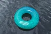 A single inflatable swim ring floating on dark water. Anteprima dell’immagine prodotto