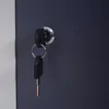A close-up of a lock and keys on a dark gray surface. Anteprima dell’immagine prodotto
