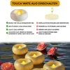 Floating LED candles with roses and lily pads on water. Produktbild-Vorschau