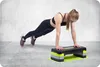 A woman is performing a plank exercise on a step platform. Voir les images du produit