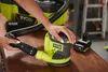 A person is connecting a vacuum hose to a Ryobi sander, with a Ryobi vacuum and battery in the background. Podgląd zdjęcia produktu