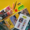 A diamond painting kit laid out on a yellow background. Produktbild-Vorschau