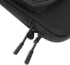 A close-up view of two black zipper pulls on a black bag. Produktbild-Vorschau