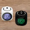 Two digital alarm clocks, one white and one black, are placed on a wooden surface. Produktbild-Vorschau