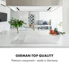 A modern kitchen counter with a white induction stovetop in the foreground and a dining area in the background. Podgląd zdjęcia produktu